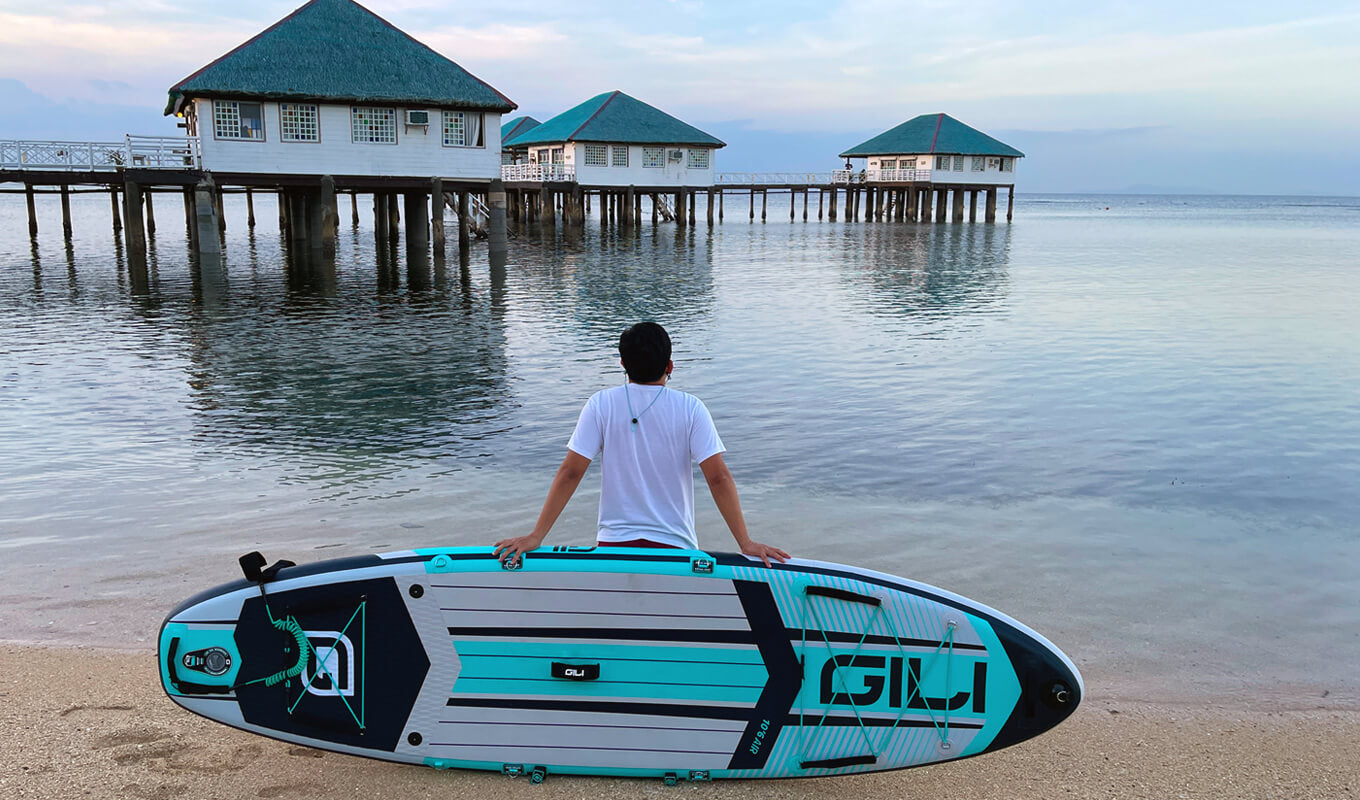 Man leaning on his inflatable paddle board