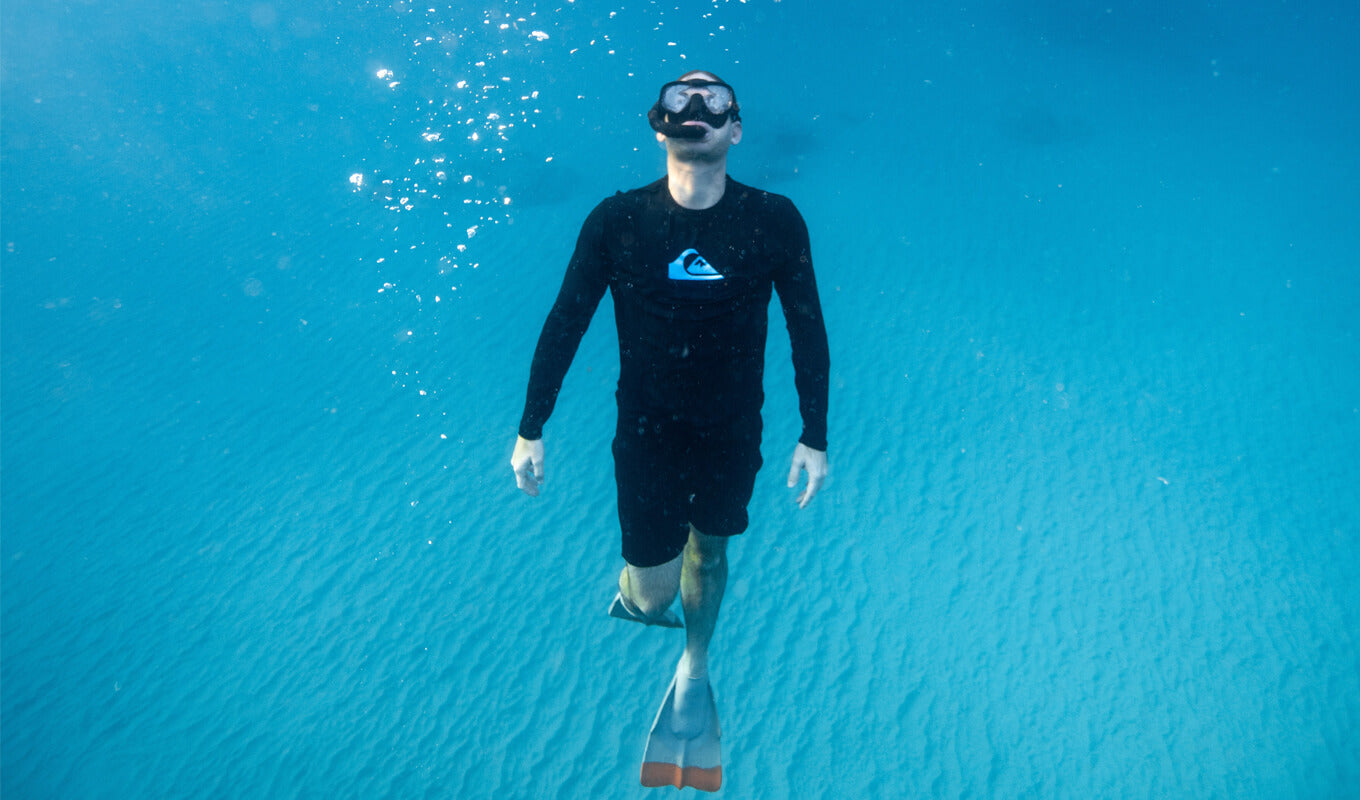 Man wearing a rash guard while diving