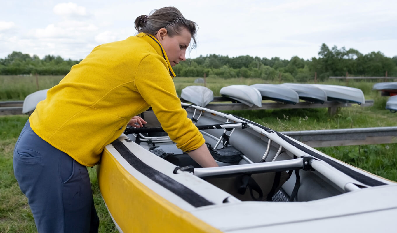 Woman cleaning the interior of her kayak