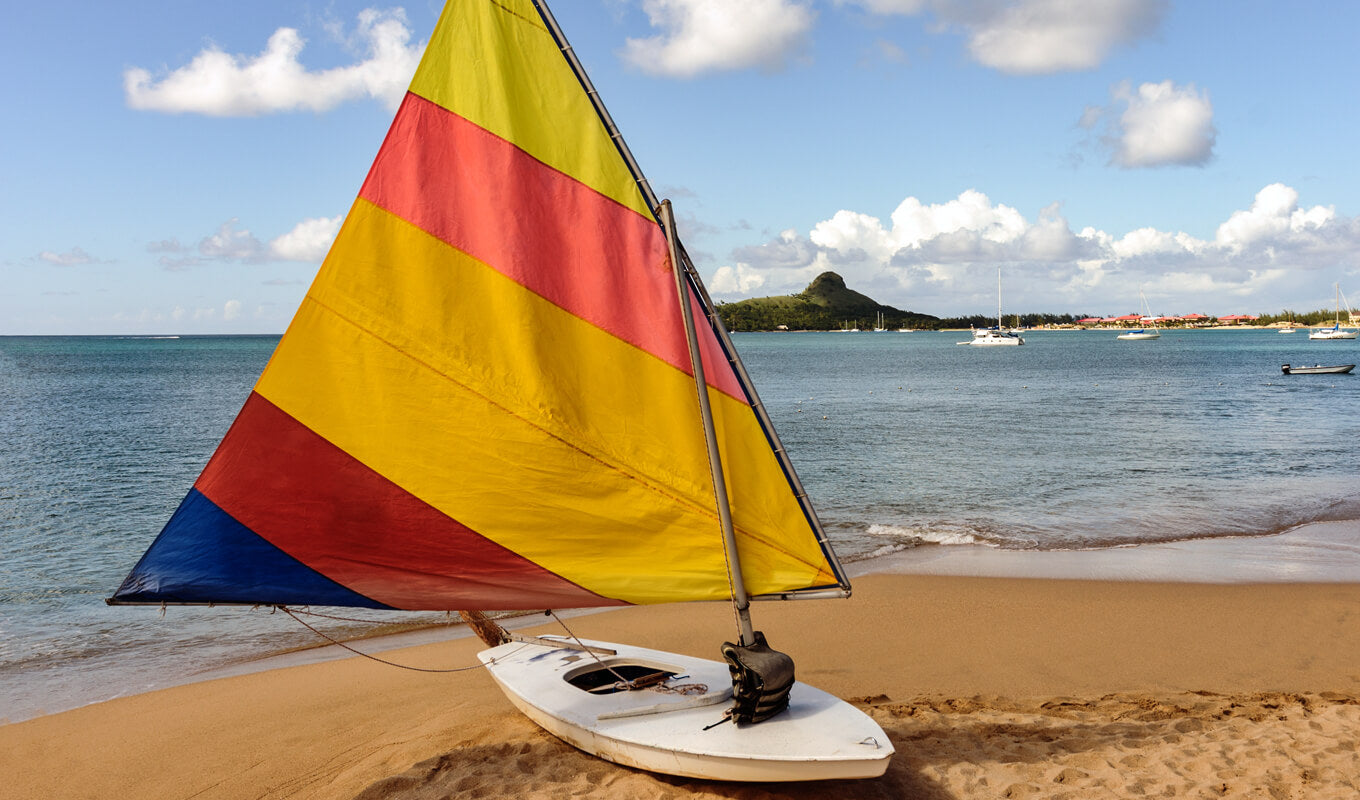White wooden wood boat with a sail