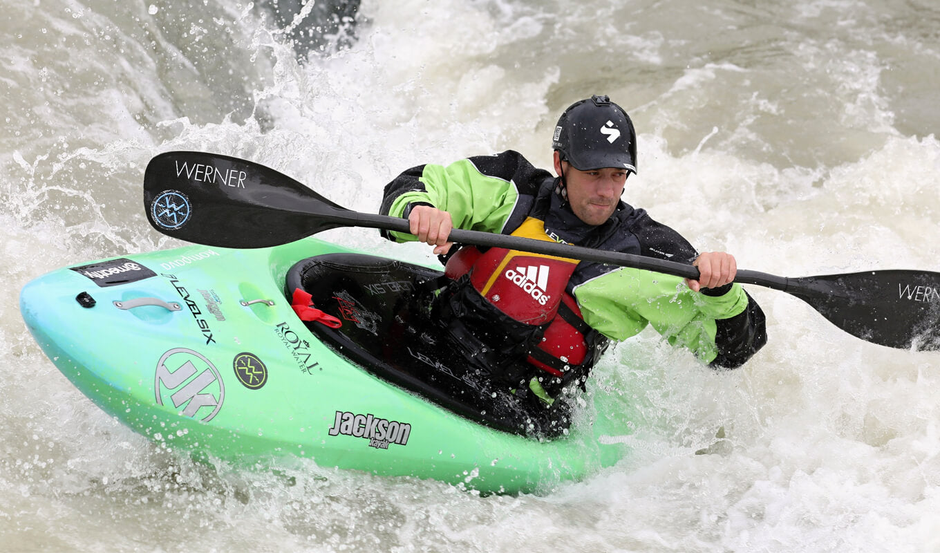 Man wearing a kayak spray skirt on a recreational kayak