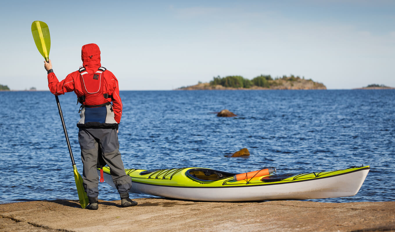 Man wearing a red jacket while kayaking