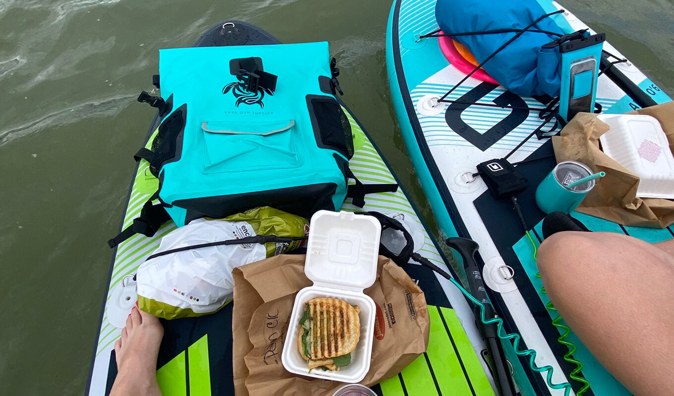 Man and a woman eating food on a GILI Mako sup