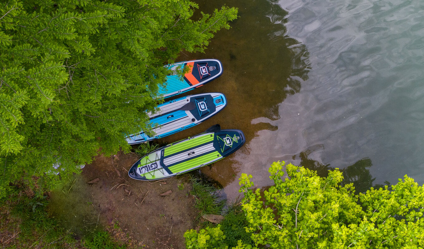 three inflatable paddle boards on a river
