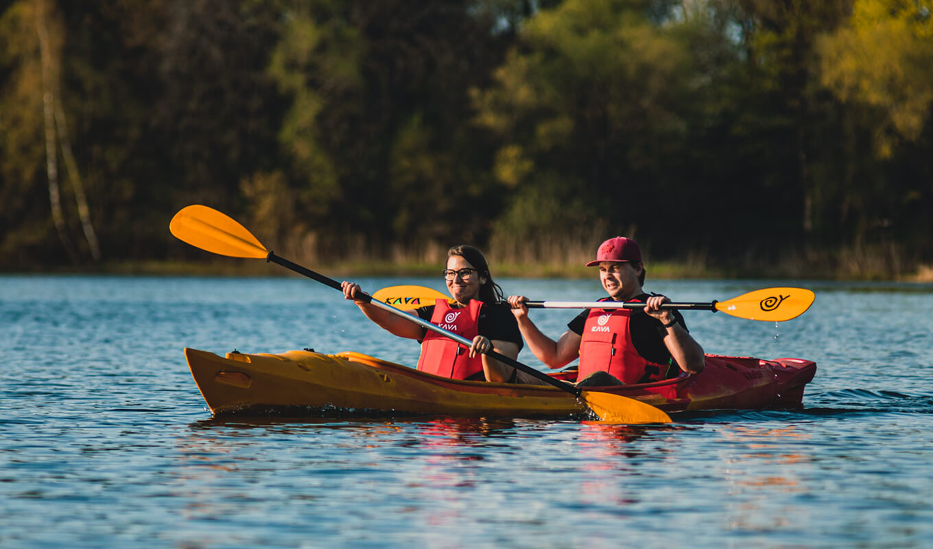 Man and a woman wearing a life jacket while kayaking