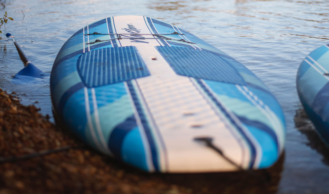 Blue and white soft top paddle board