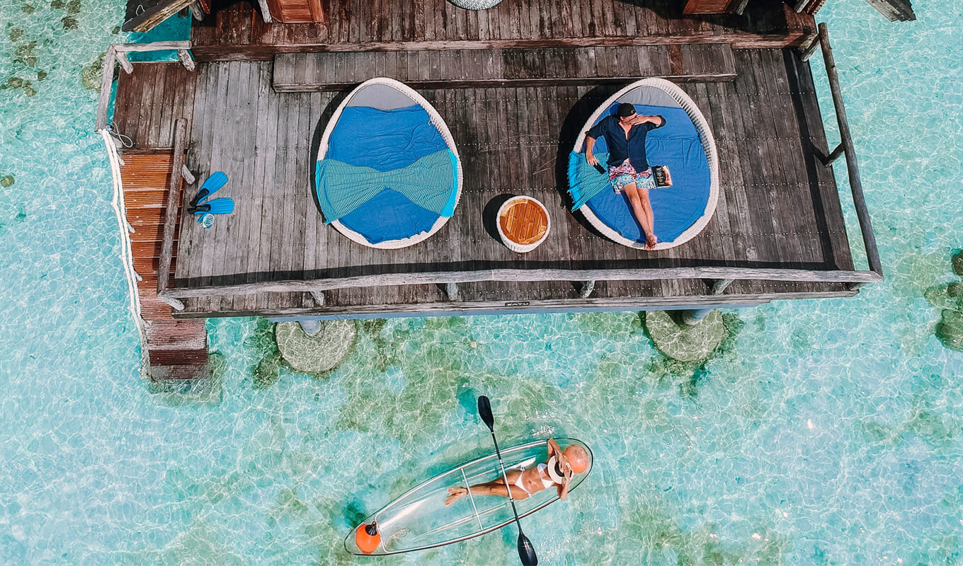 Woman lying on a clear kayak