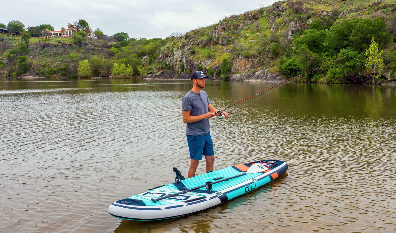 Man fly fishing on a GILI inflatable paddle board