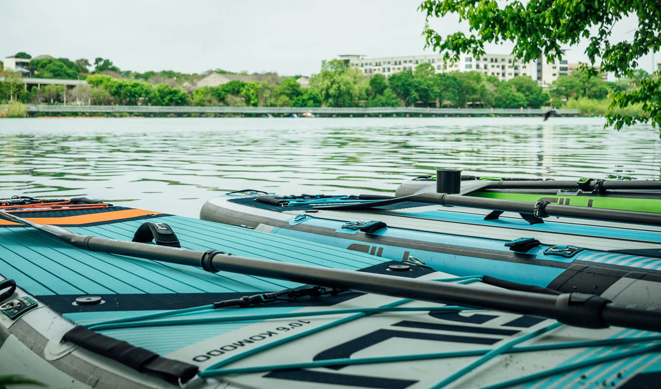 Inflatable paddle boards at a river