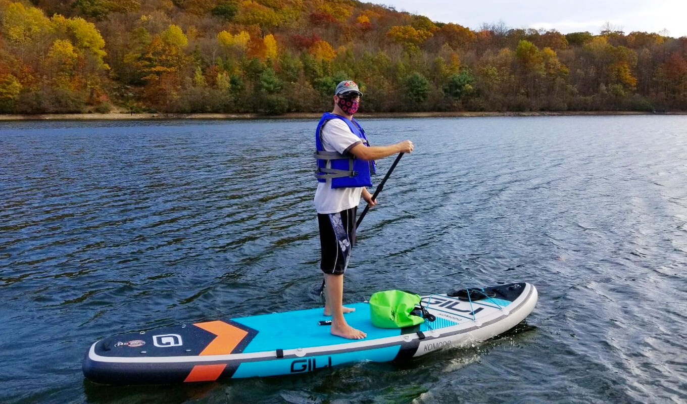 Man paddle boarding with complete accessories