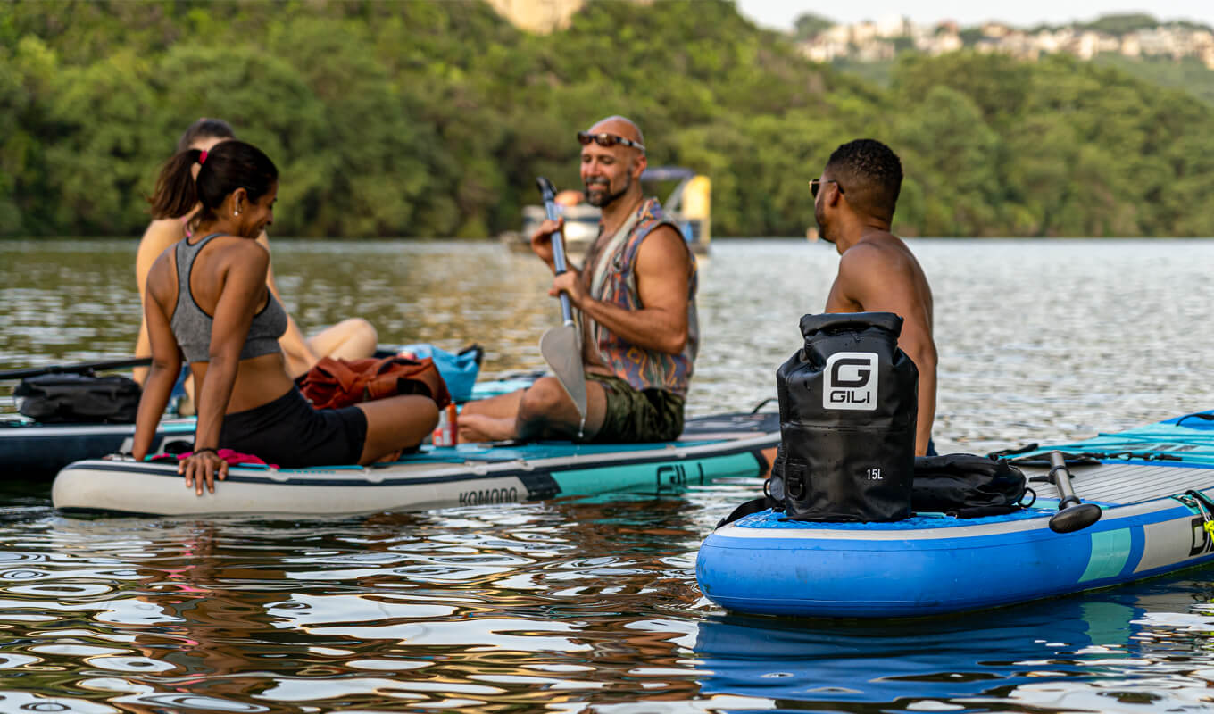 Man and woman on inflatable stand up paddle boards