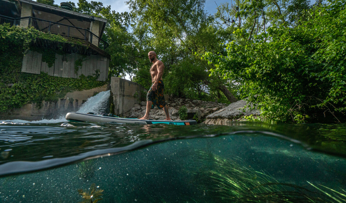 Man on his paddle board doing his yoga